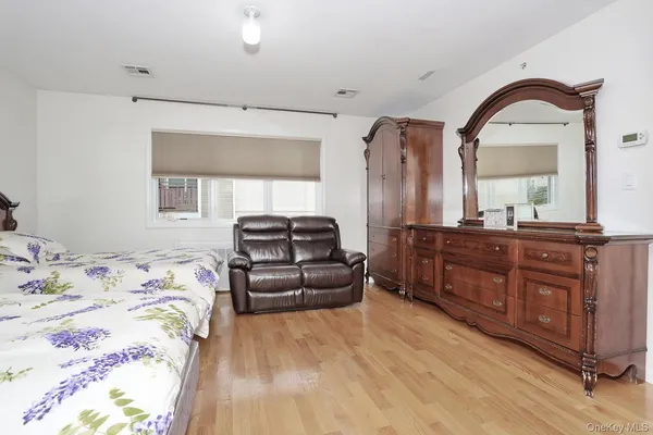 a bedroom with a bed and a dresser