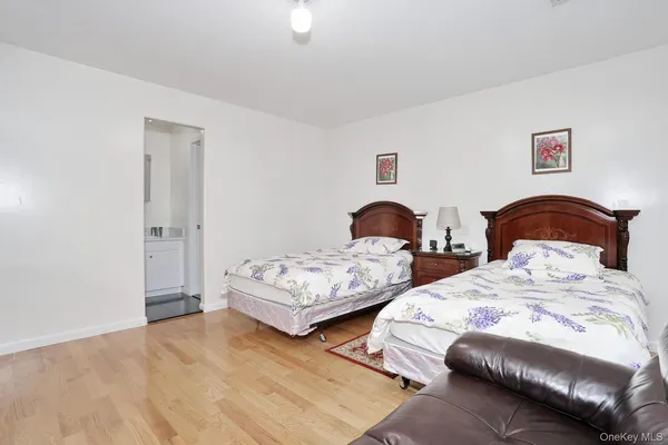 a bedroom with two beds and a dresser