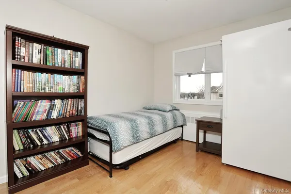 a bedroom with a bed and a book shelf