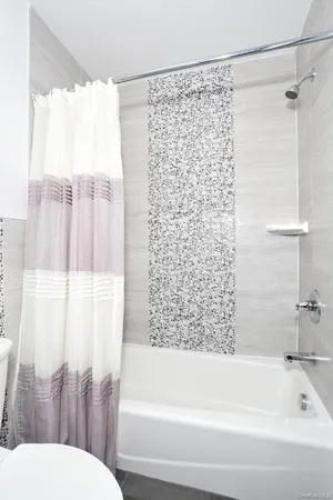 a bathroom with a bathtub and shower