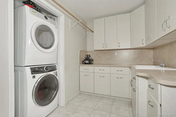 a utility room with sink dryer and washer