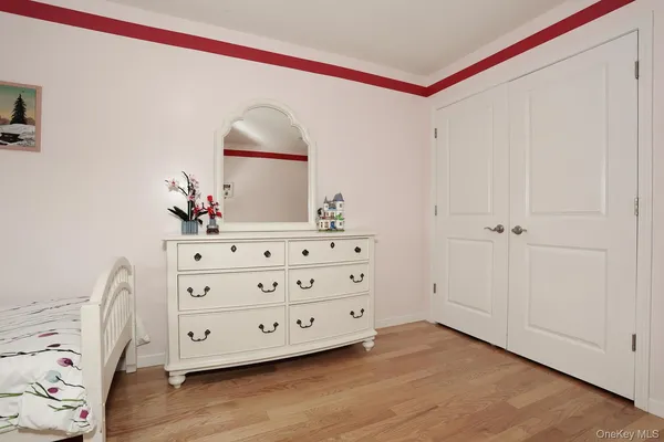 a room with a dresser and mirror
