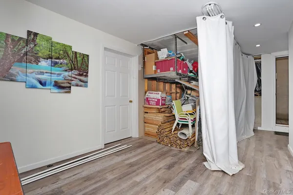 a view of a room with wooden floor and ceiling fan