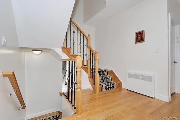 a view of a livingroom with wooden floor and stairs