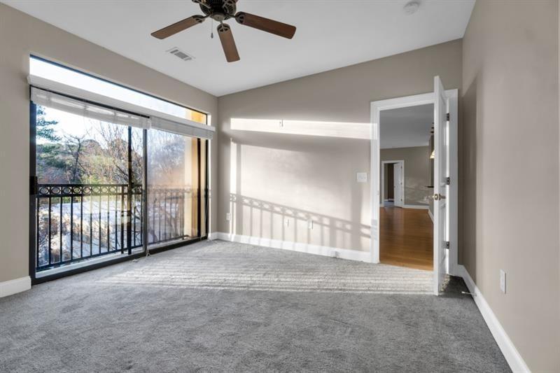 2230 Cheshire Bridge Road Northeast, Unit 412 Atlanta, GA 30324 - Photo 12 of 35 a view of a room with a ceiling fan and windows