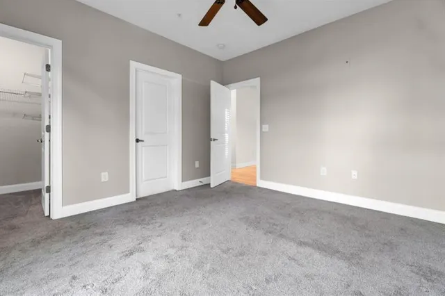 an empty room with chandelier fan