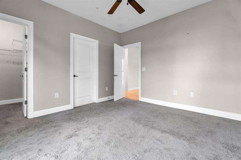 2230 Cheshire Bridge Road Northeast, Unit 412 Atlanta, GA 30324 - Photo 28 of 35 an empty room with chandelier fan