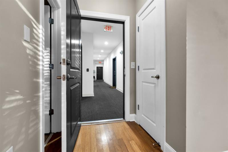 2230 Cheshire Bridge Road Northeast, Unit 412 Atlanta, GA 30324 - Photo 30 of 35 a view of a hallway with wooden floor and a bathroom