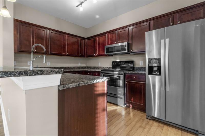 2230 Cheshire Bridge Road Northeast, Unit 412 Atlanta, GA 30324 - Photo 7 of 35 a kitchen with stainless steel appliances granite countertop a refrigerator stove and oven