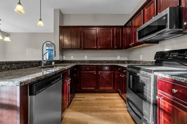a kitchen with wooden cabinets and a stove top oven