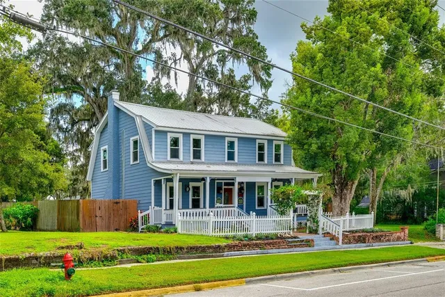 a front view of house with yard and green space