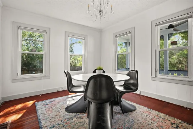 a workspace with hardwood floor and windows