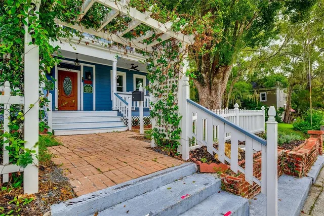 a view of a house with backyard and wooden stairs