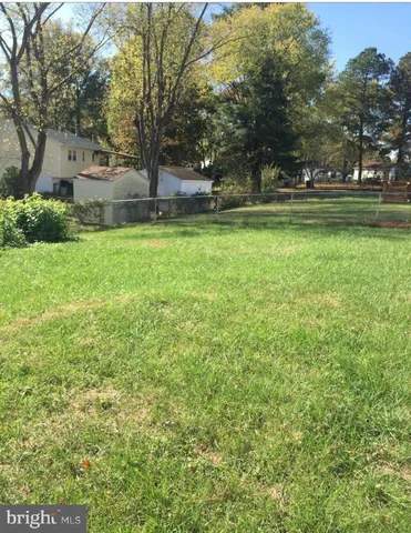 a backyard of a house with lots of green space and fountain