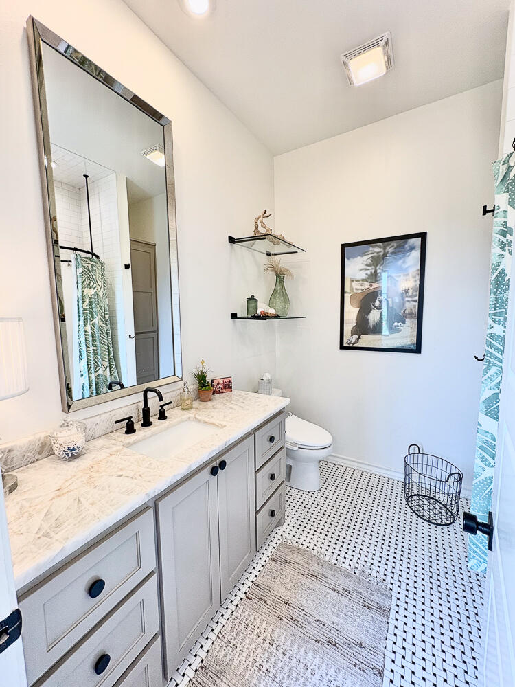 5902 112th Street Lubbock, TX 79424 - Photo 26 of 45 a bathroom with a sink and a mirror