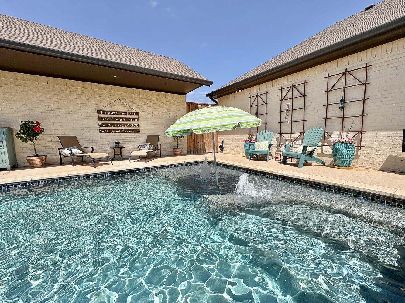 5902 112th Street Lubbock, TX 79424 - Photo 30 of 45 a backyard of a house with table and chairs under an umbrella