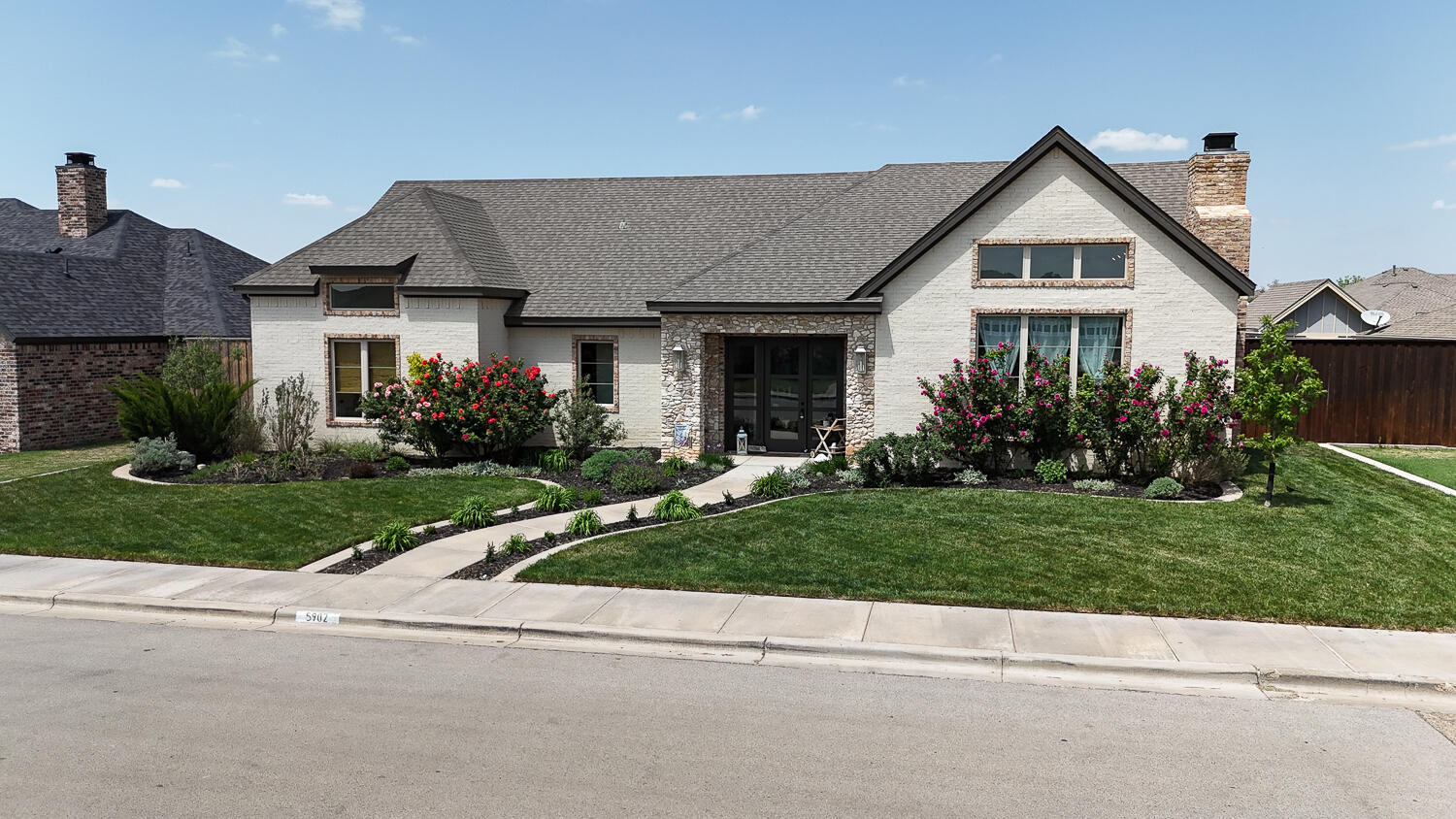 5902 112th Street Lubbock, TX 79424 - Photo 38 of 45 a front view of a house with a yard and a garage