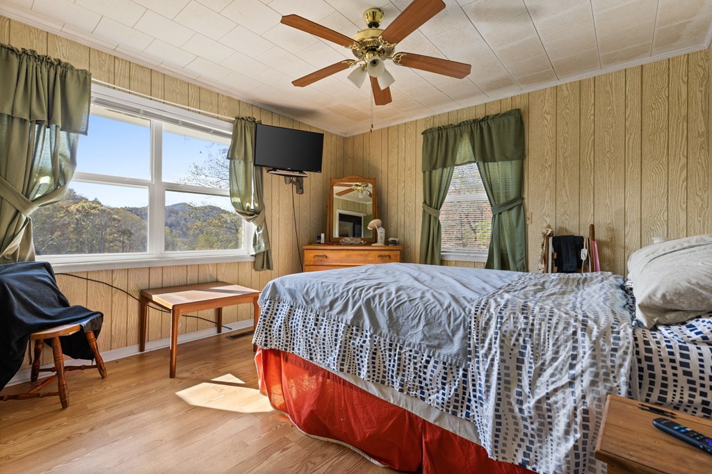 492 Johnny Gap Road Suches, GA 30572 - Photo 12 of 16 a bed sitting in a bedroom next to a window