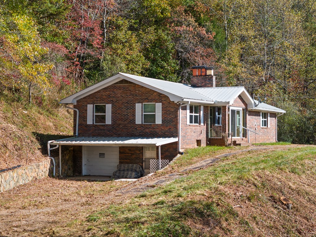 492 Johnny Gap Road Suches, GA 30572 - Photo 2 of 16 a front view of a house with a yard and garage