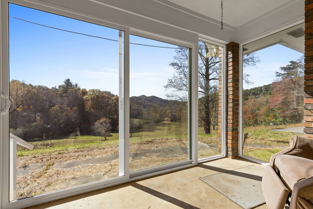 492 Johnny Gap Road Suches, GA 30572 - Photo 6 of 16 a view of a porch with a floor to ceiling window chair and floor to ceiling window