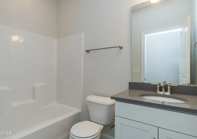 a kitchen with a refrigerator and a stove top oven