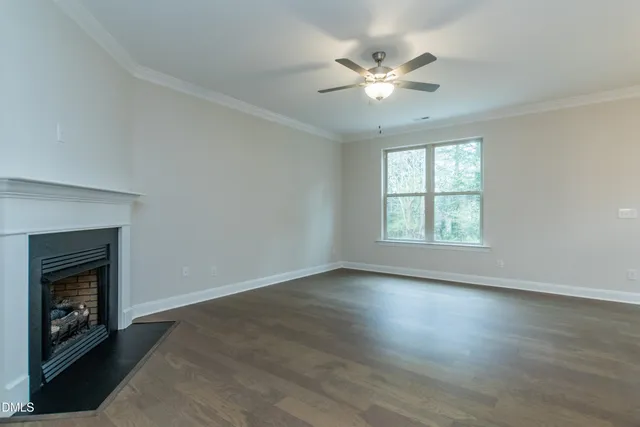 a large kitchen with a fireplace and cabinets