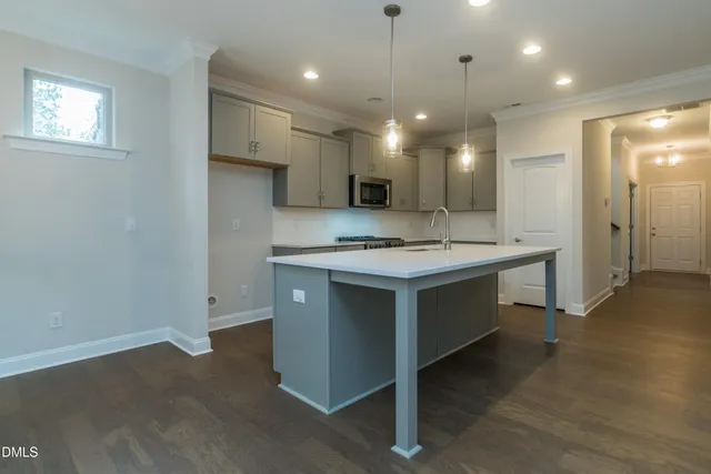 a kitchen with a sink and chandelier