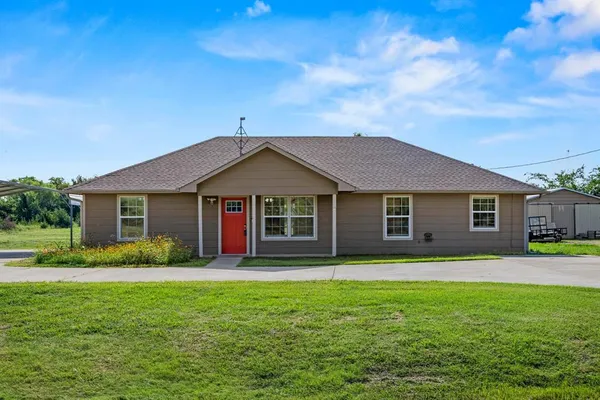 a front view of house with yard and green space