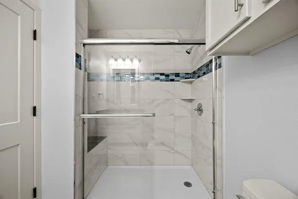 a bathroom with a glass shower door