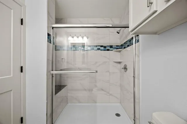 a bathroom with a glass shower door