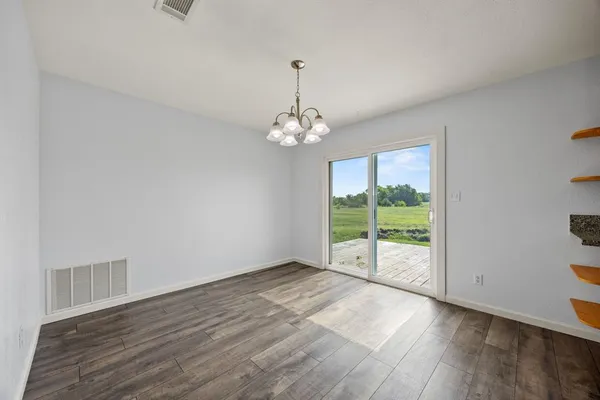 a view of a room with wooden floor and outdoor view