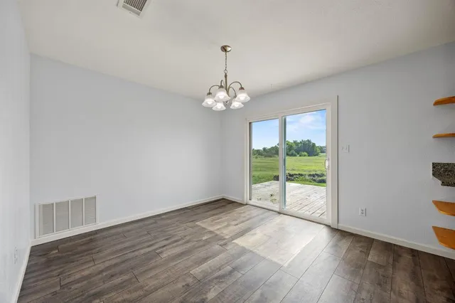 a view of a room with wooden floor and outdoor view