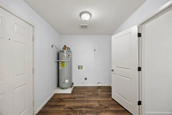 a view of a hallway with wooden floor and entryway