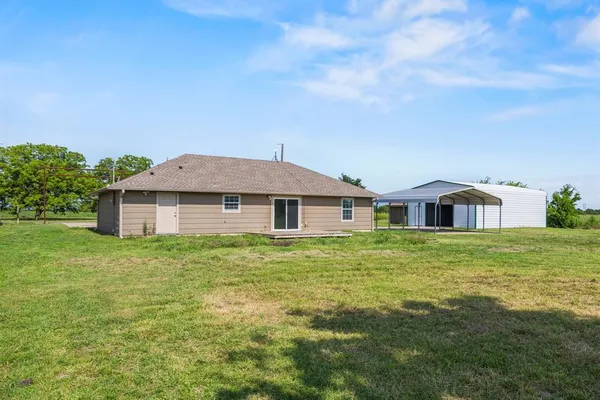 a view of a big yard in front of a house with a yard
