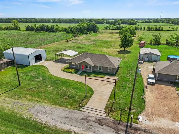 an aerial view of a house with big yard