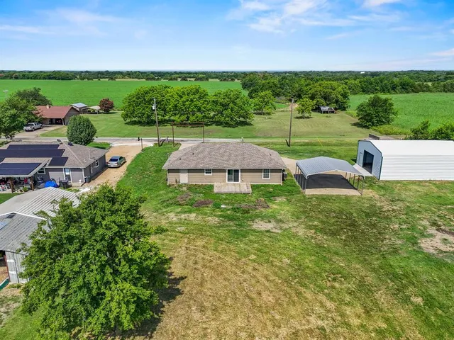 a view of a garden with an outdoor seating