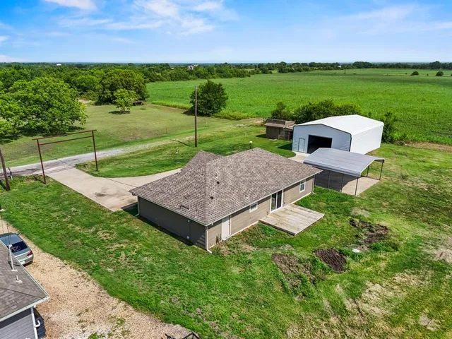 an aerial view of a house with a garden and trees