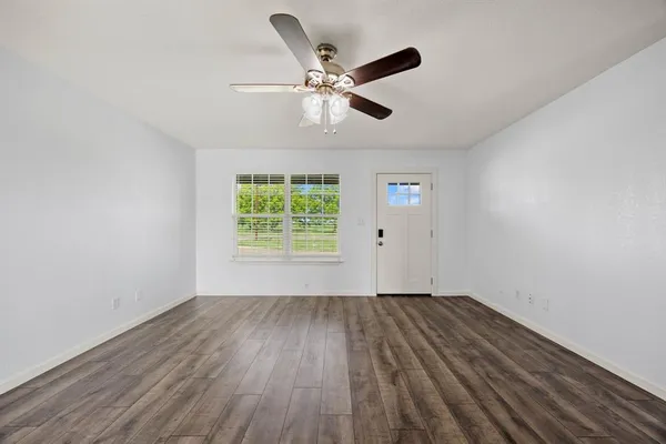 wooden floor in an empty room with a window