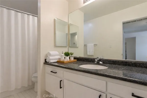 a bathroom with a double vanity sink and a mirror