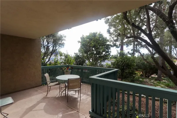 a view of a two chairs in the balcony