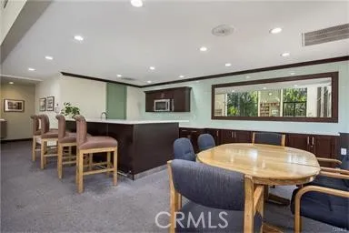 a view of a dining room with furniture and a large window