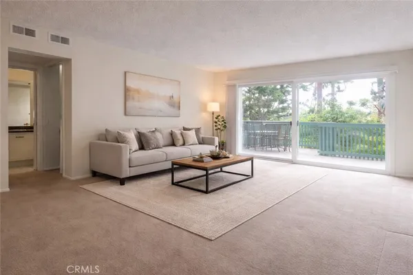 a living room with furniture and a floor to ceiling window
