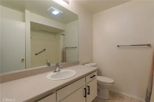 a bathroom with a sink a toilet and mirror