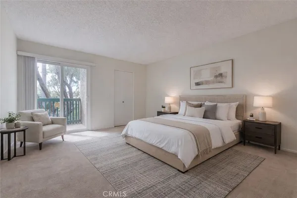 a spacious bedroom with a bed and a couch