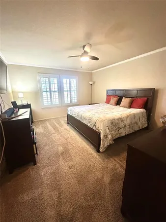 a spacious bedroom with a bed and a chandelier