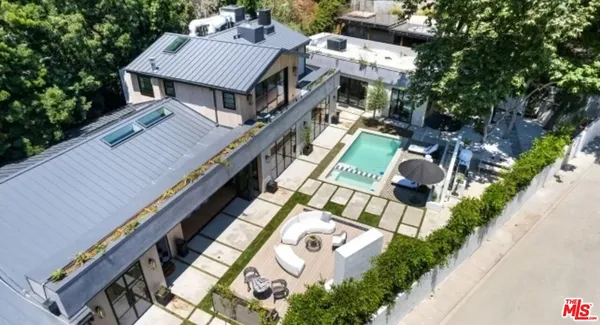 a aerial view of a house with a yard and balcony