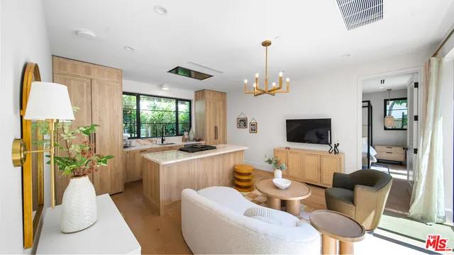 a living room with furniture a flat screen tv and a large window