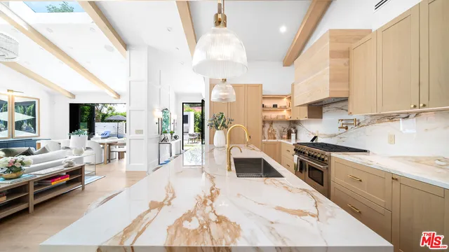 a large kitchen with stainless steel appliances kitchen island granite countertop a large center island attached withe living room