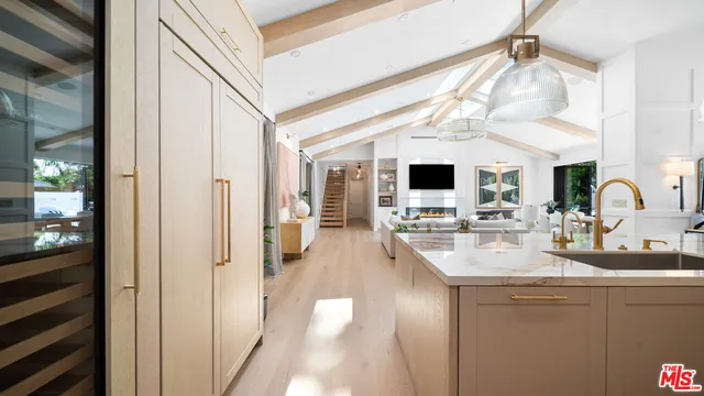 a kitchen with a sink appliances and a window