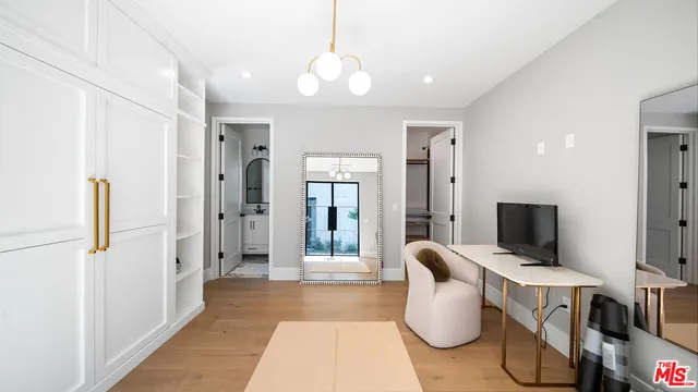 a hallway with couches and flat screen tv
